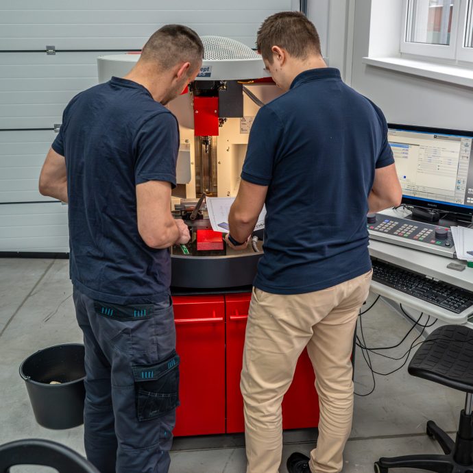 Precízna príprava pred frézovaním Lektor a študent kontrolujú technický výkres pri nastavovaní CNC frézy EMCO Concept Mill 55